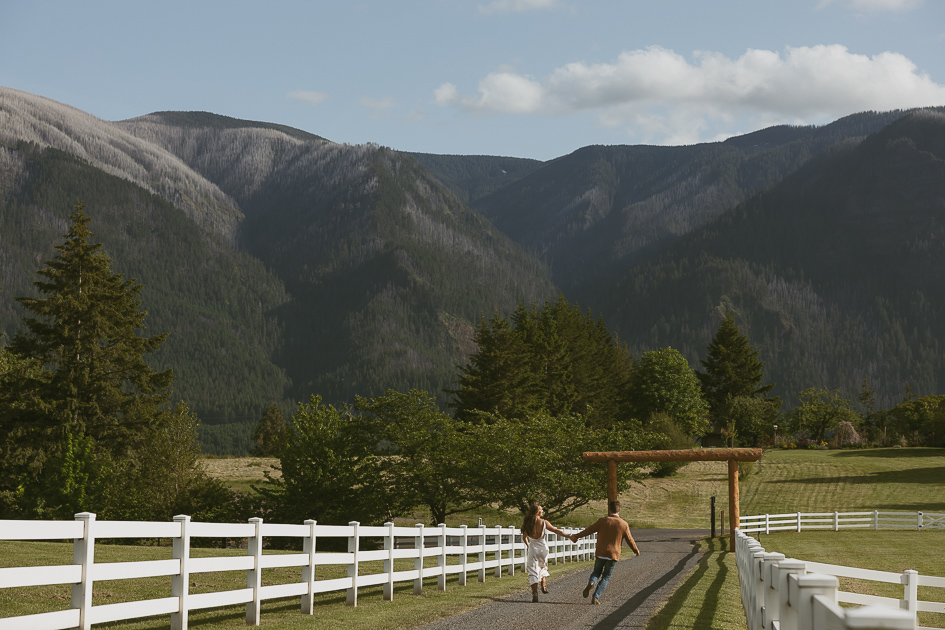 A wedding couple down the gravel road at Wind Mountain Ranch.