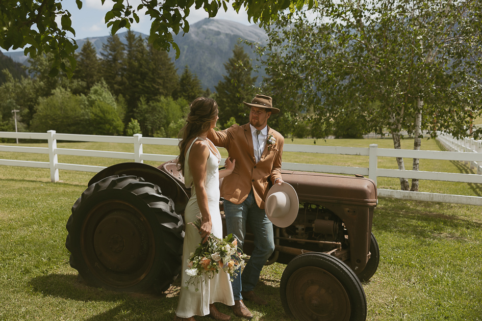 A wedding couple share a quiet moment in the orchard at Wind Mountain Ranch.
