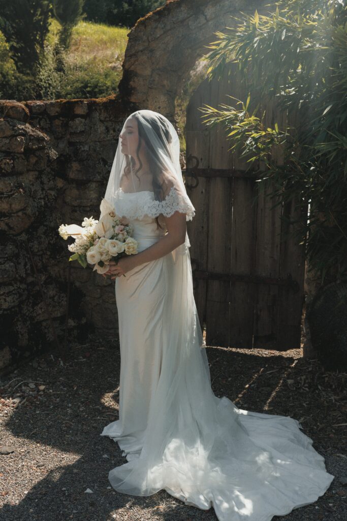 Bride posing in front of the ivy-covered stone walls at Villa Catalana Cellars