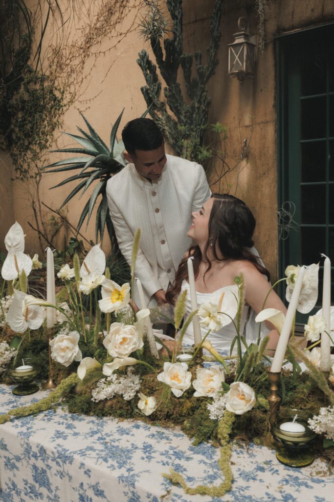 Romantic atrium reception setup at Villa Catalana Cellars with Mediterranean architecture in the background