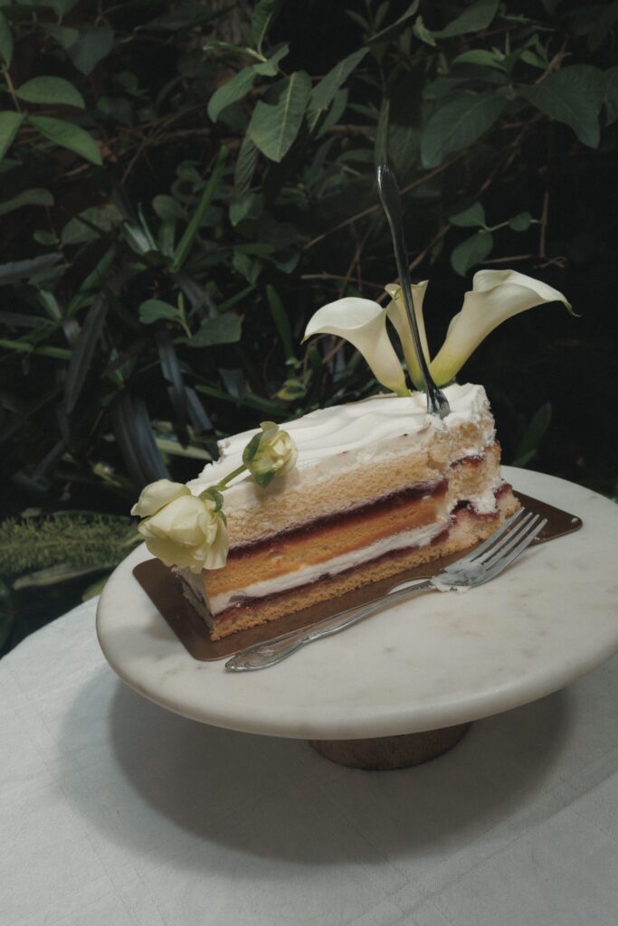 Close-up of calla lily wedding cake on marble stone table at Villa Catalana Cellars wedding reception