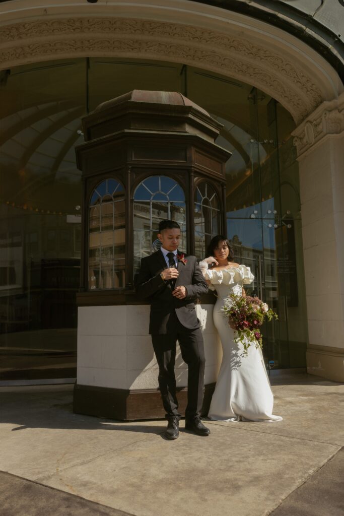Couple sharing quiet moment after ceremony, editorial wedding photography style in downtown Astoria