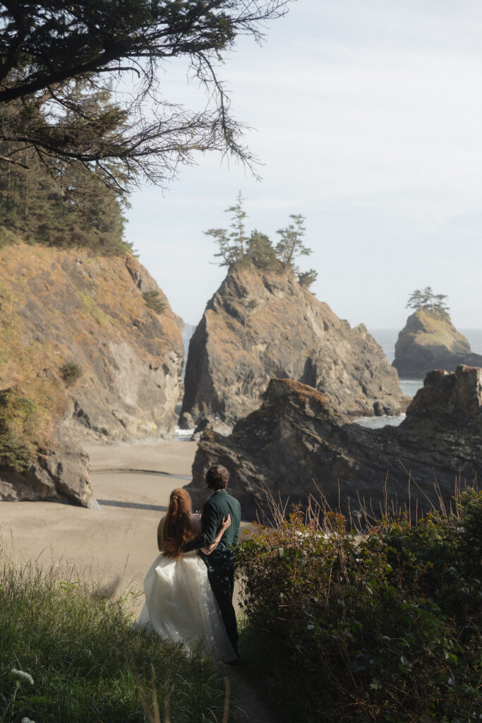 Elopement couple enjoying the view from the trail at Secret Beach in Brookings, OR