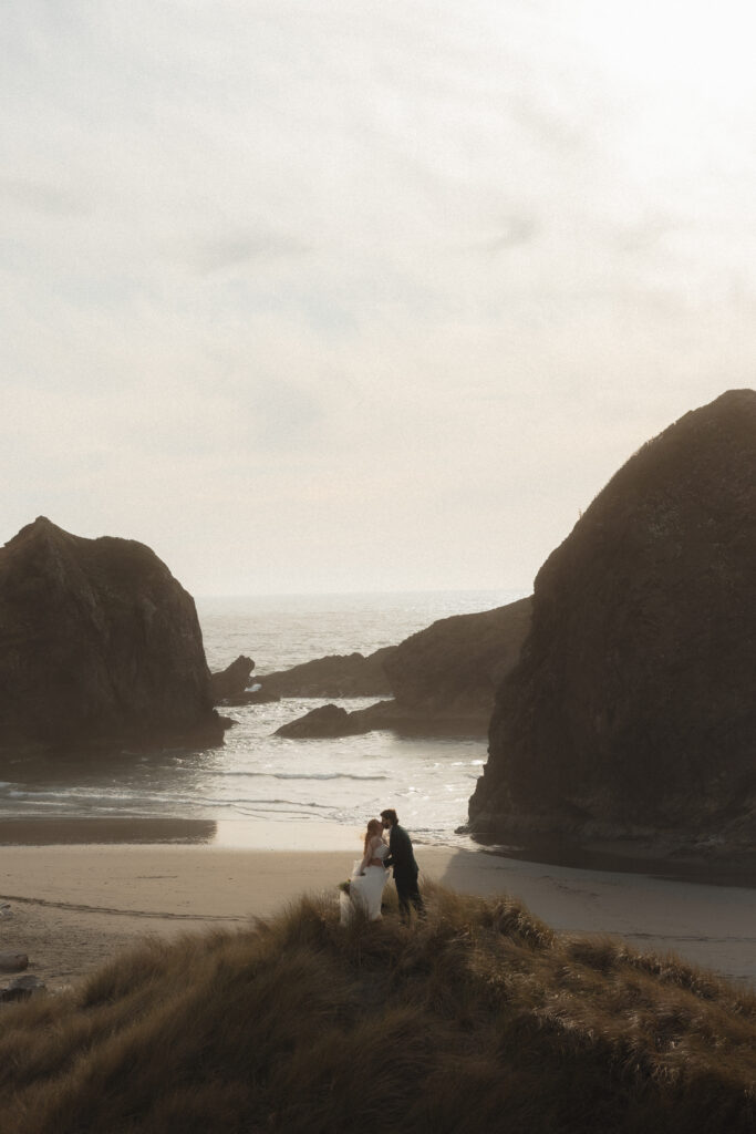 Elopement couple sharing a kiss at Amiya's Beach in Brookings, OR
