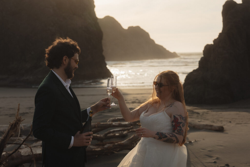 Elopement couple cheersing Amiya's Beach in Brookings, OR
