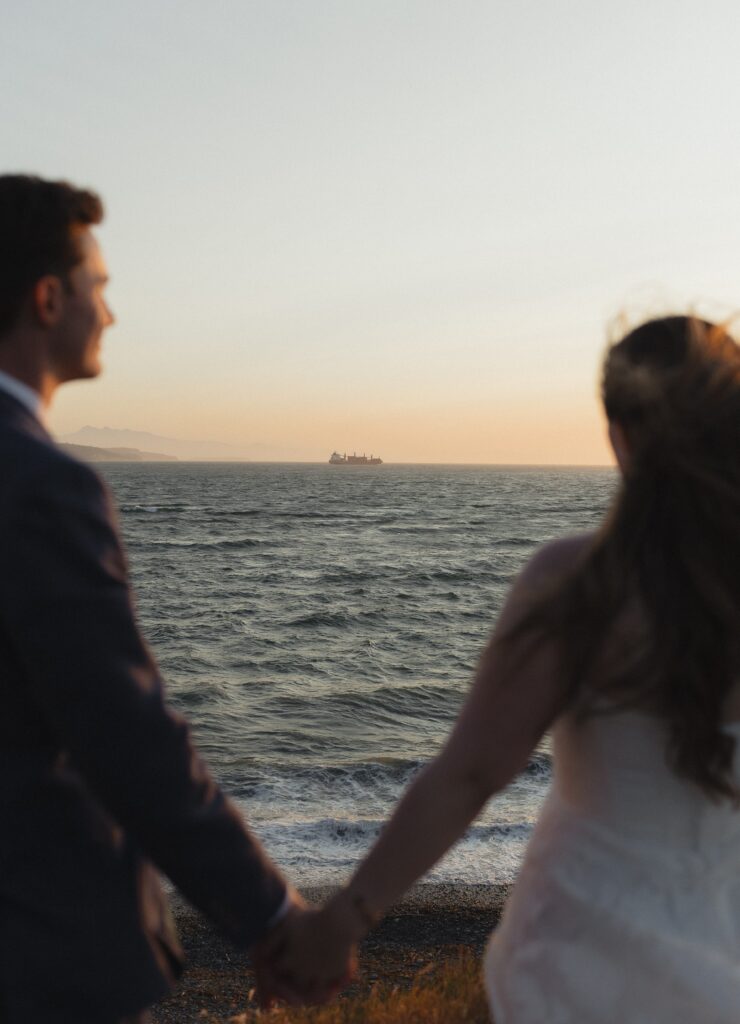 Wedding couple watching boat on Whidbey Island