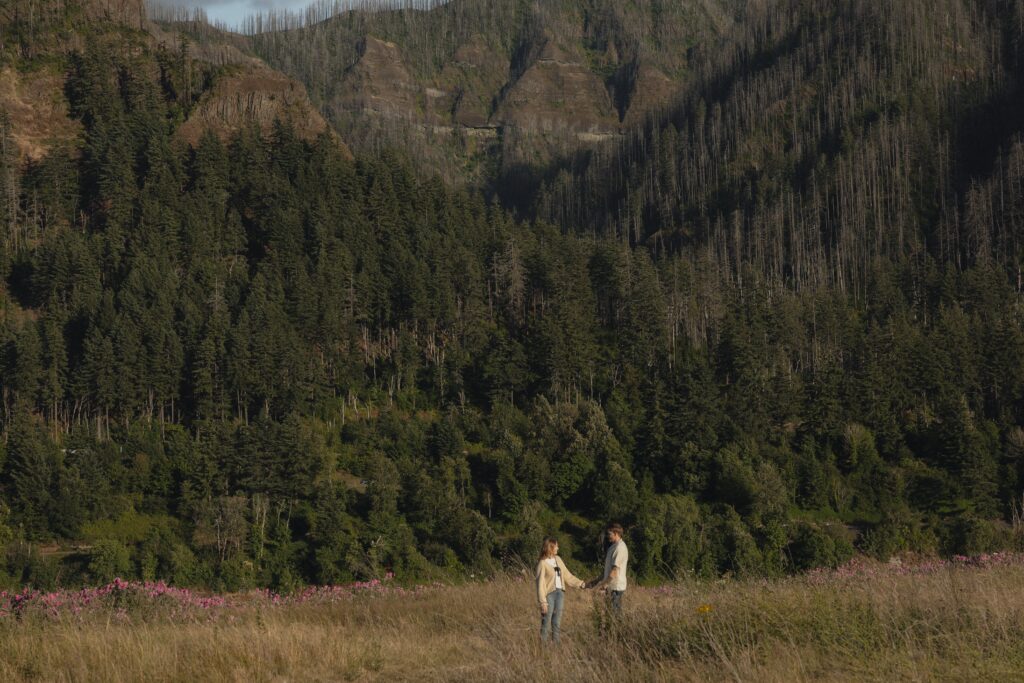 Intimate moment of an engaged couple holding hands in the Columbia River Gorge