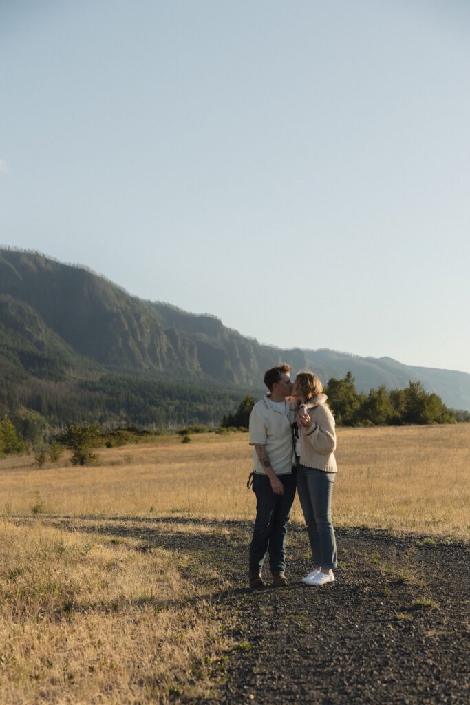 engaged couple shares a kiss in Bonneville, WA