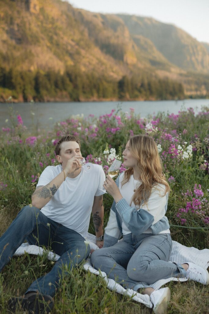 Captured by their Washington engagement photographer, a couple shares a glass of wine together