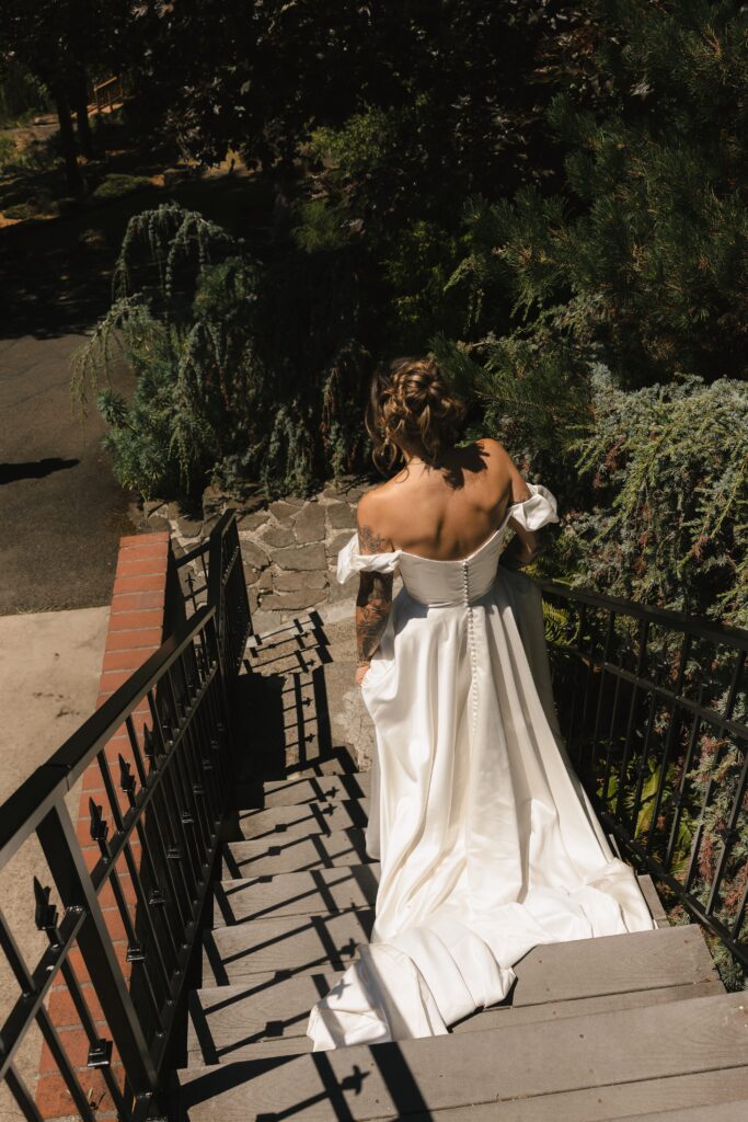 Bride wearing thrifted wedding dress with hot pink mule block heels during Mount Tom House celebration