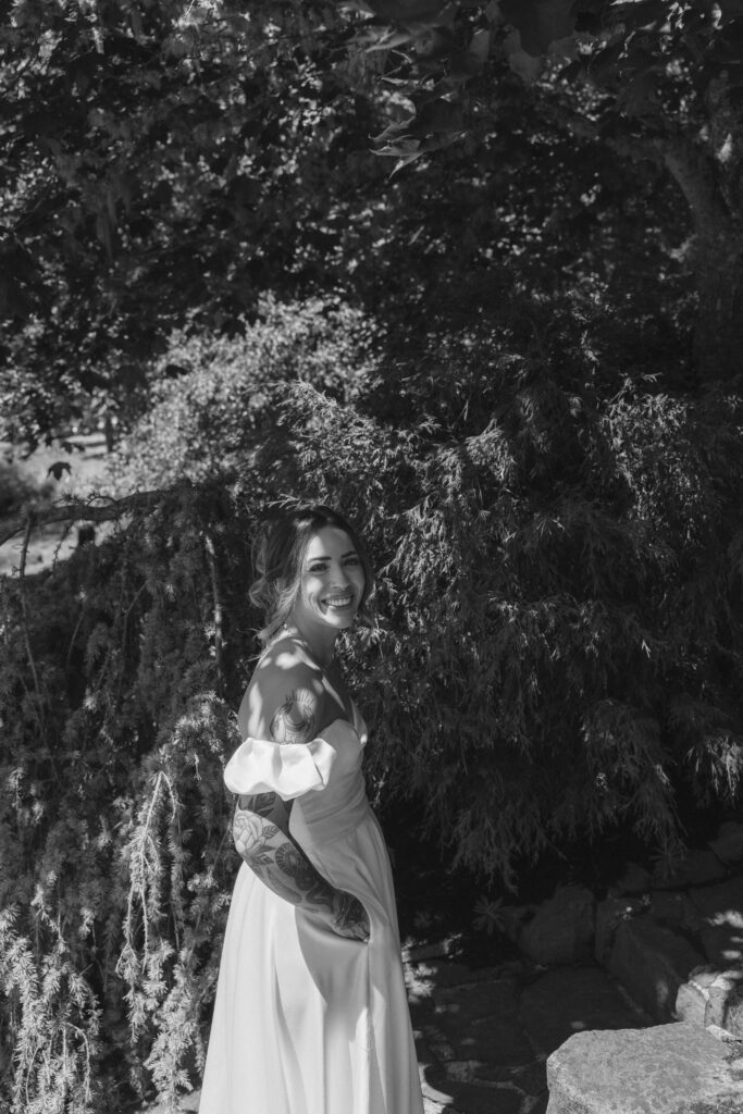 Bride wearing thrifted wedding dress with hot pink mule block heels during Mount Tom House celebration