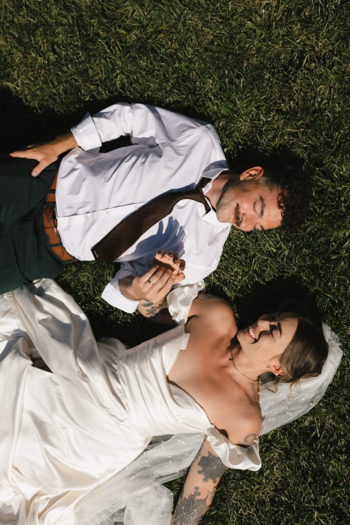 Bride wearing thrifted wedding dress with hot pink mule block heels during Mount Tom House celebration