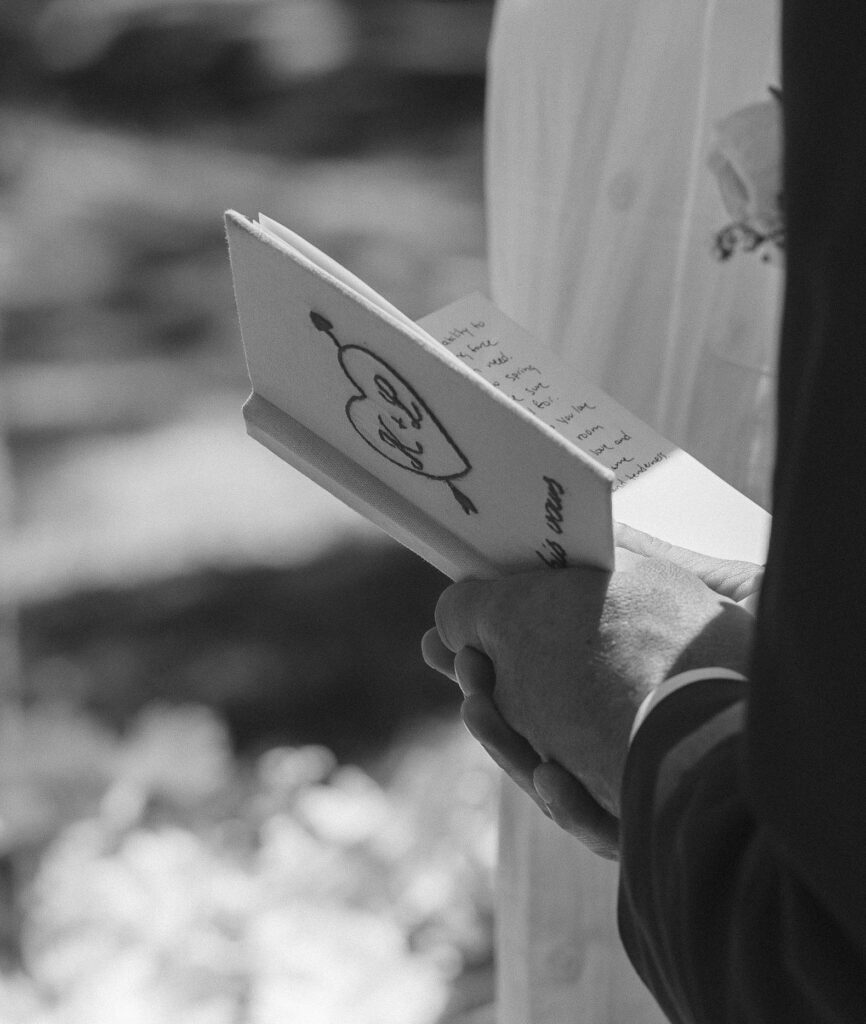 Custom vow books for couple during intimate wedding celebration