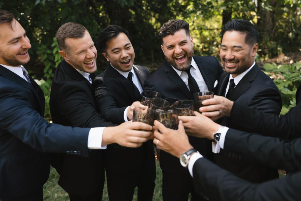 Wedding party sharing a drink on the Ceremony Lawn.