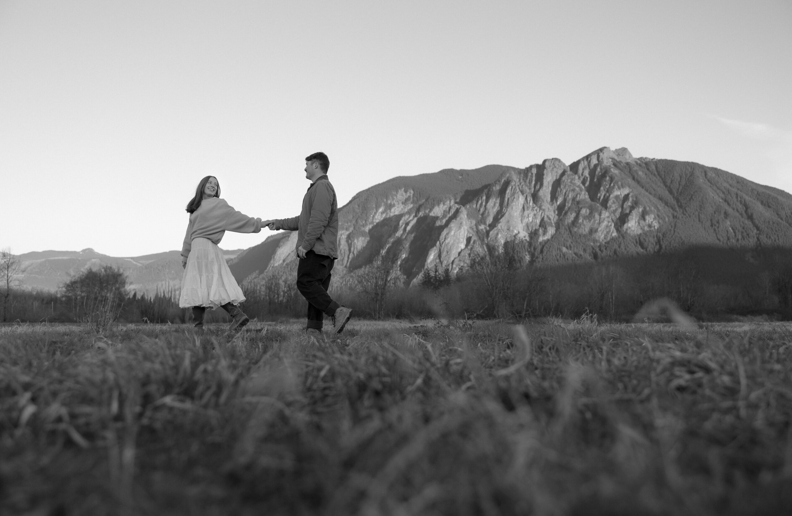 Abby and Henry walking through Elk Fields in Snoqualmie with Mount Si in the distance