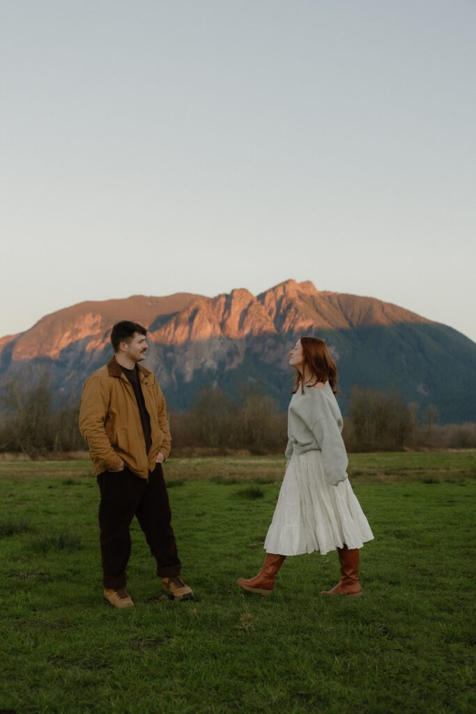 Abby and Henry walking through Elk Fields in Snoqualmie with Mount Si in the distance