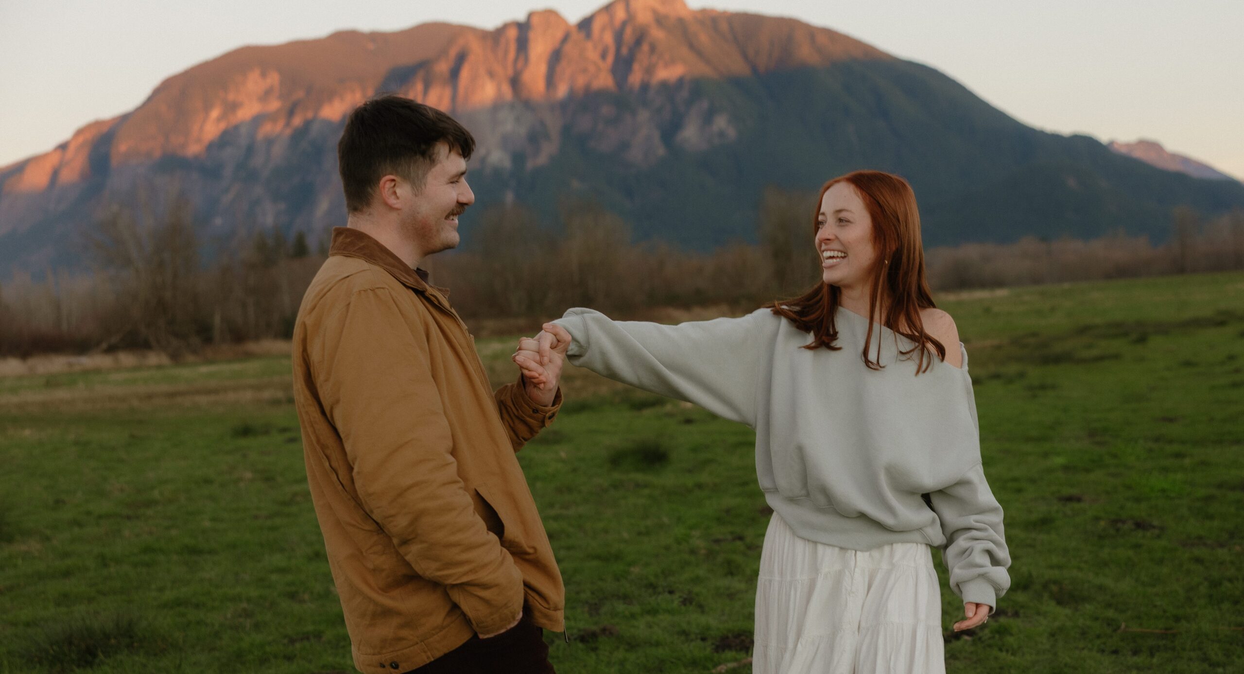 Couple laughing during Elk Fields engagement photos in Snoqualmie