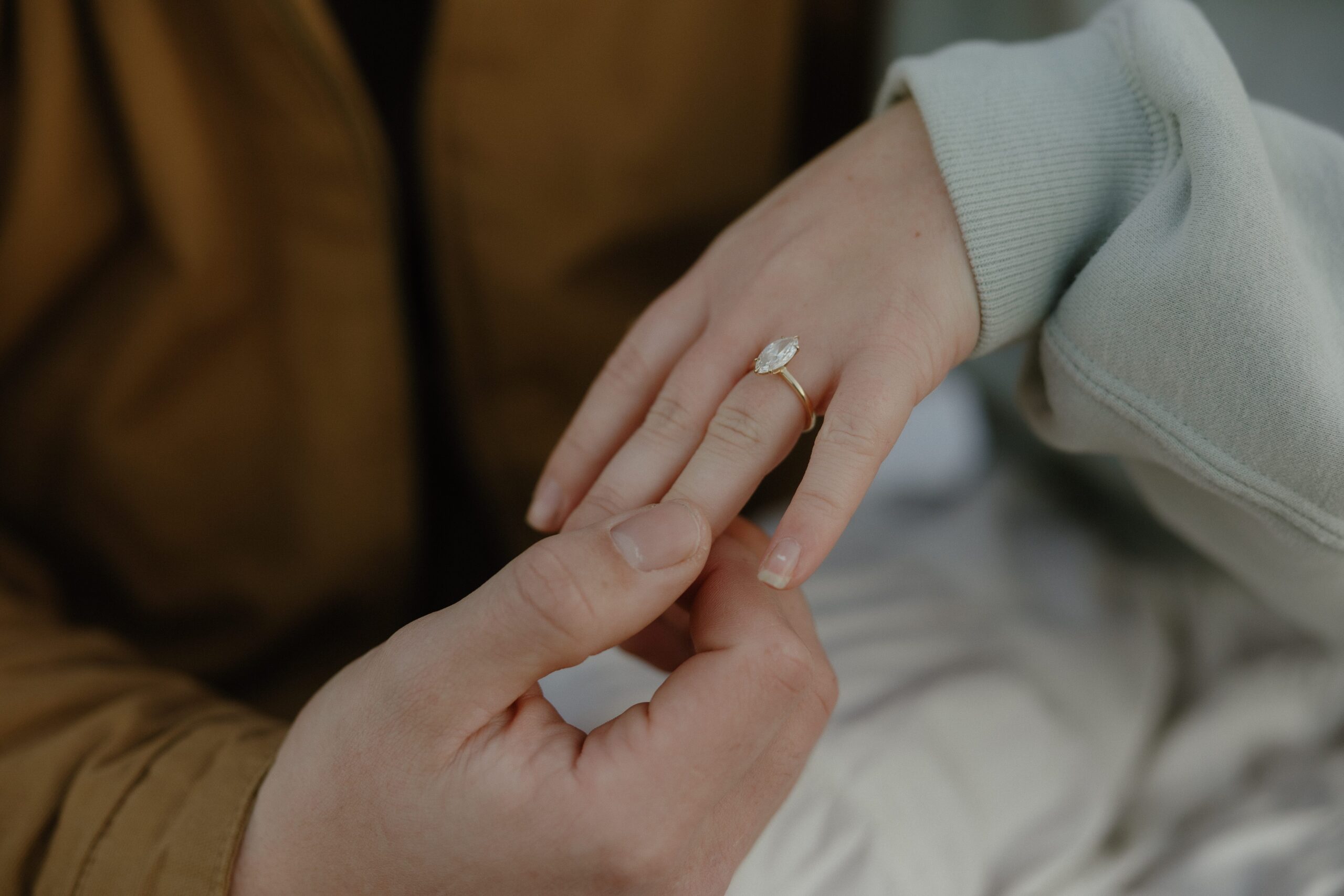 Engagement ring photos at Elk Fields with soft grasses and mountain views