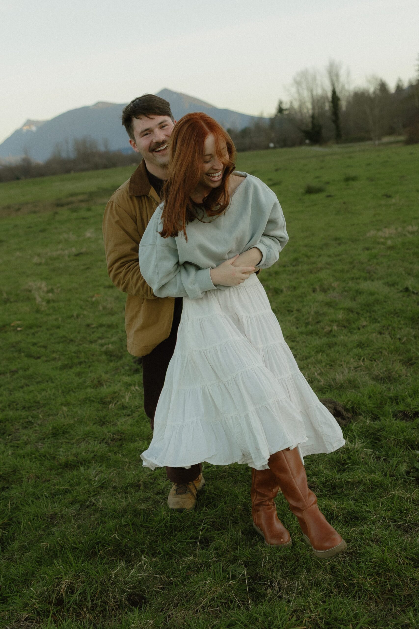 Couple laughing during Elk Fields engagement photos in Snoqualmie