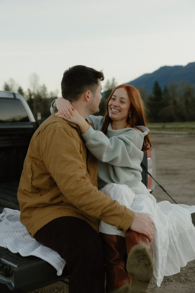 Couple laughing during Elk Fields engagement photos in Snoqualmie