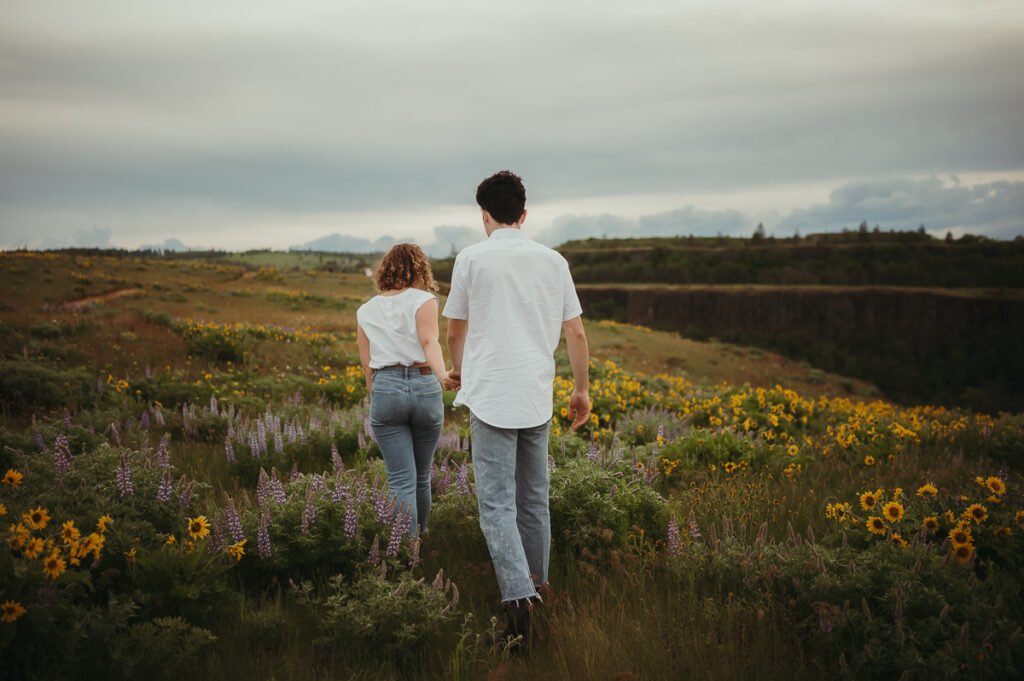 Couple walking around wildflowers in the Columbia Gorge