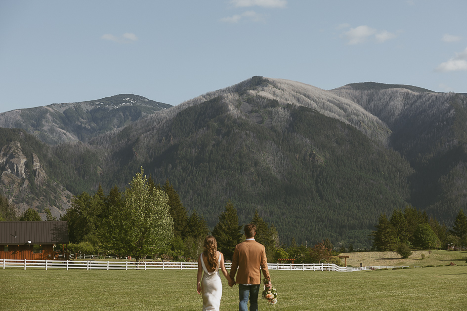 A wedding couple share a quiet moment in the orchard at Wind Mountain Ranch.